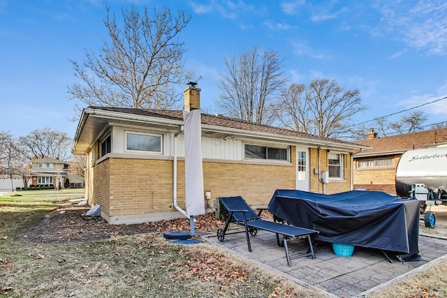 back of property with a patio