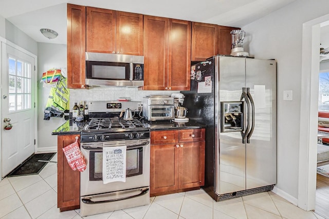 kitchen featuring light tile patterned floors and stainless steel appliances