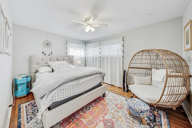 bedroom with hardwood / wood-style floors and ceiling fan