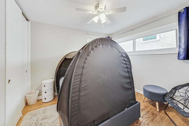 bedroom with a closet, ceiling fan, and light hardwood / wood-style flooring