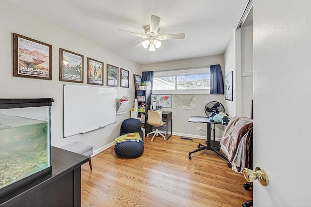 exercise area with ceiling fan and hardwood / wood-style flooring