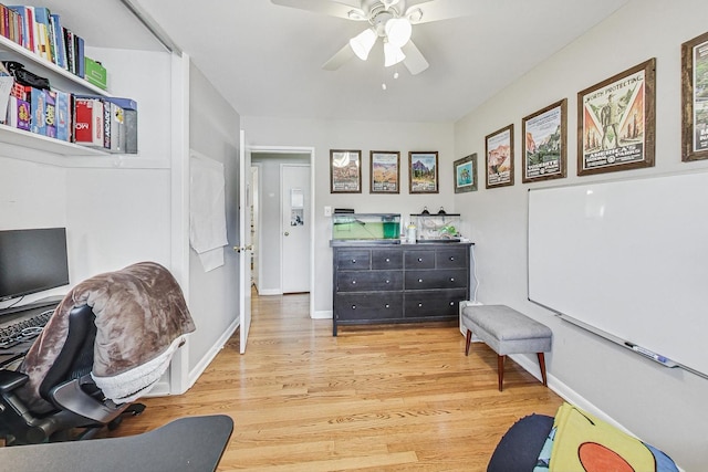 sitting room featuring wood-type flooring and ceiling fan