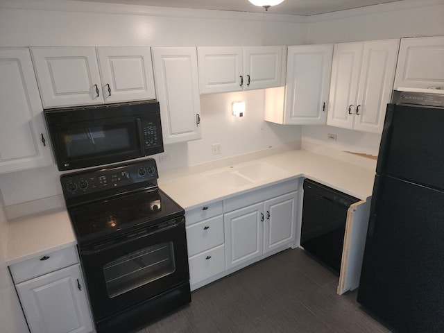 kitchen featuring white cabinets and black appliances