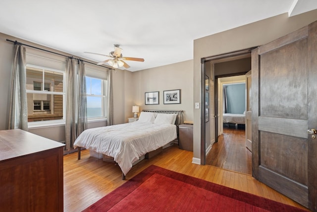 bedroom featuring light wood-style flooring and a ceiling fan