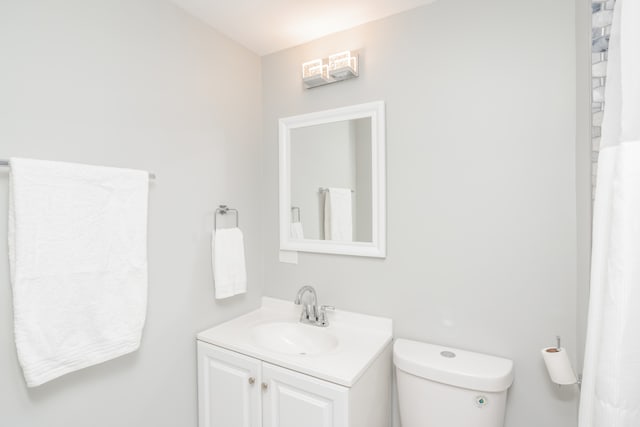 bathroom featuring vanity and toilet