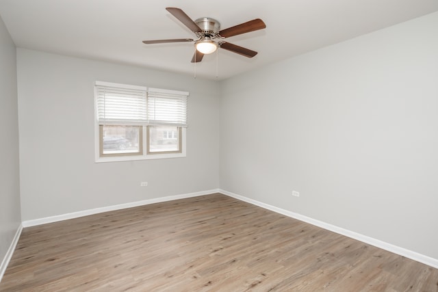 empty room with ceiling fan and light hardwood / wood-style flooring