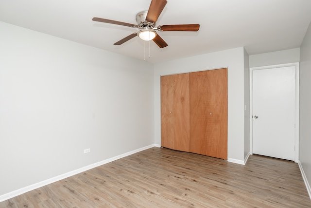 unfurnished bedroom with a closet, ceiling fan, and light hardwood / wood-style flooring