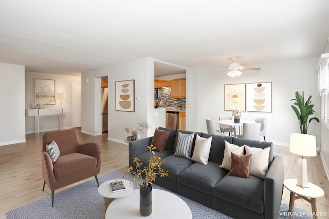 living room featuring light hardwood / wood-style flooring and ceiling fan