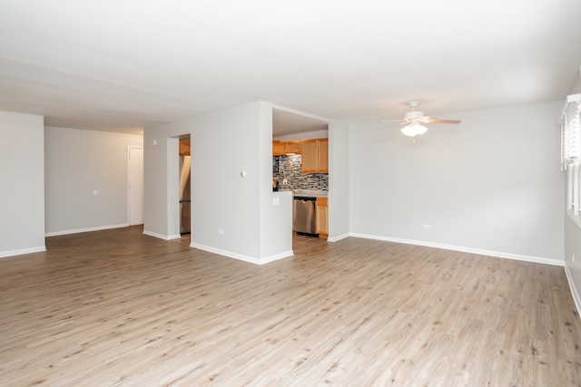 unfurnished living room featuring ceiling fan and light hardwood / wood-style floors