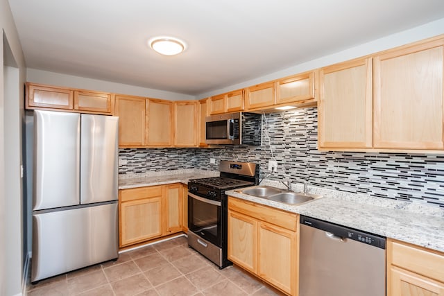 kitchen featuring backsplash, light brown cabinets, stainless steel appliances, and sink