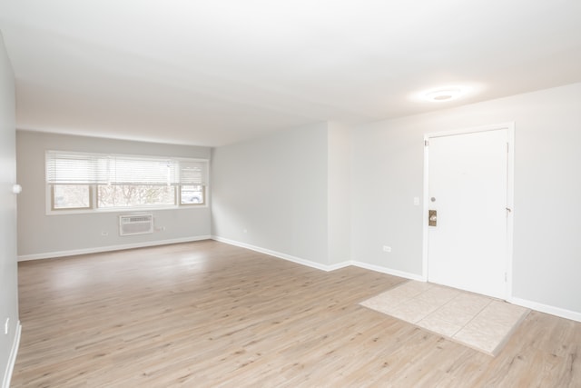 entryway featuring light wood-type flooring and an AC wall unit