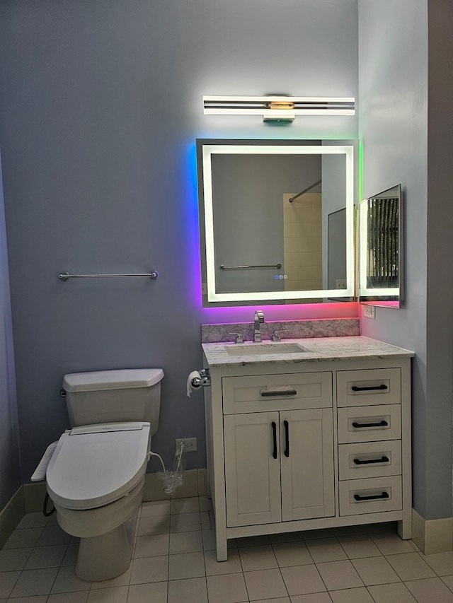 bathroom with tile patterned floors, vanity, and toilet