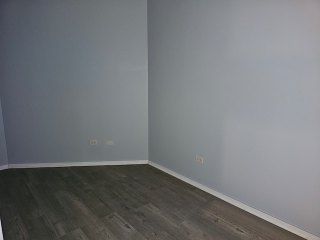 unfurnished room with dark hardwood / wood-style floors