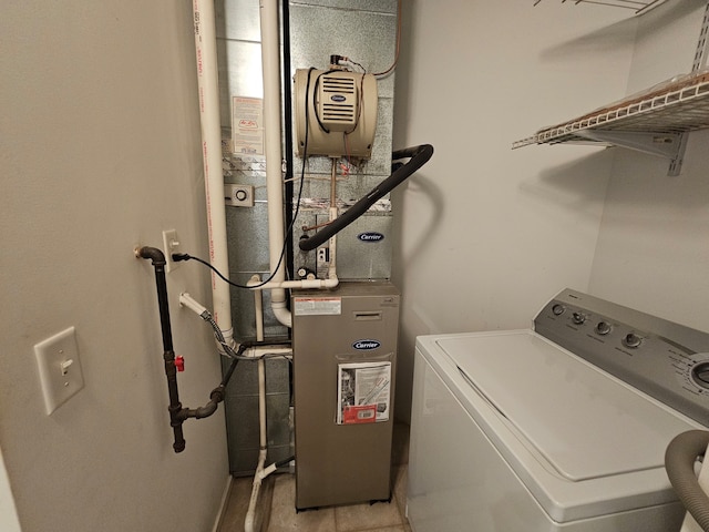 laundry room with washer / clothes dryer and light tile patterned flooring