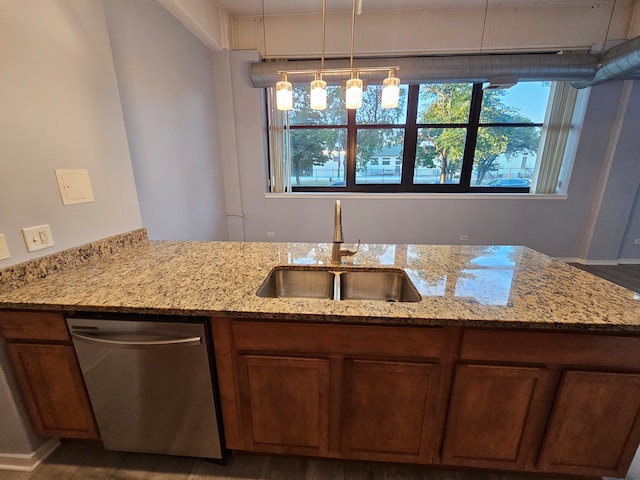 kitchen with dishwasher, sink, light stone counters, dark hardwood / wood-style flooring, and pendant lighting