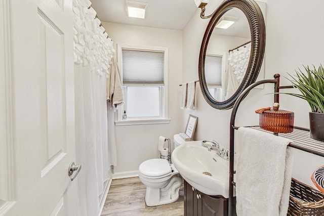 bathroom with sink, wood-type flooring, and toilet