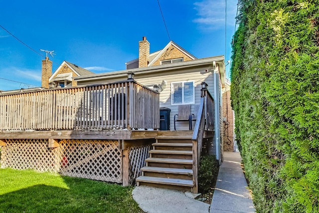 back of house featuring a wooden deck