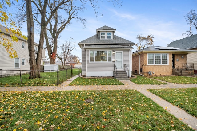 bungalow-style home with a front yard