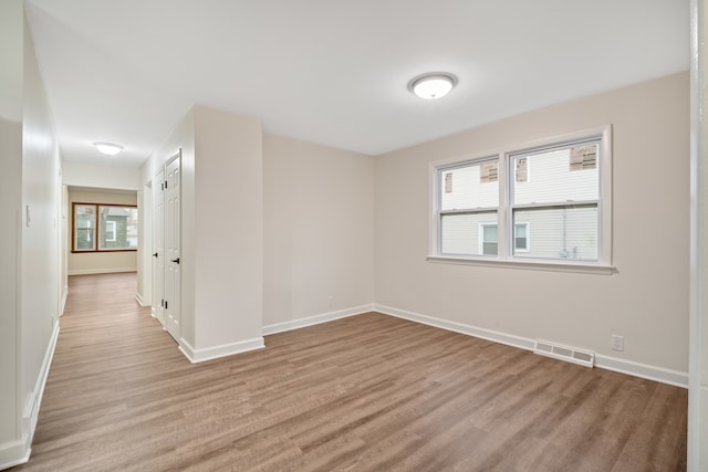 empty room with plenty of natural light and light wood-type flooring