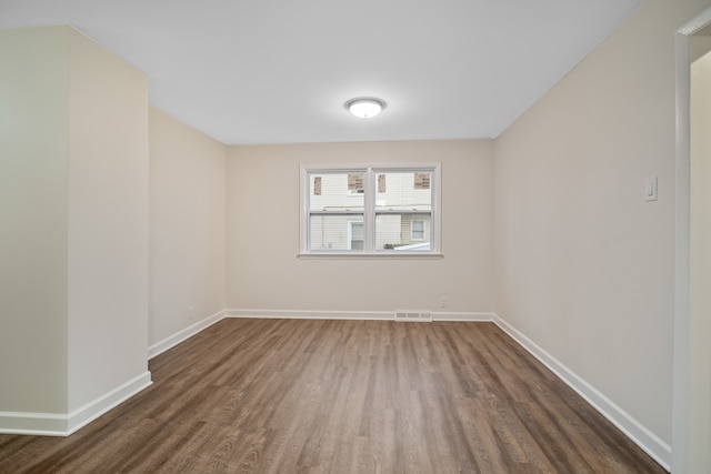 unfurnished room featuring dark hardwood / wood-style floors