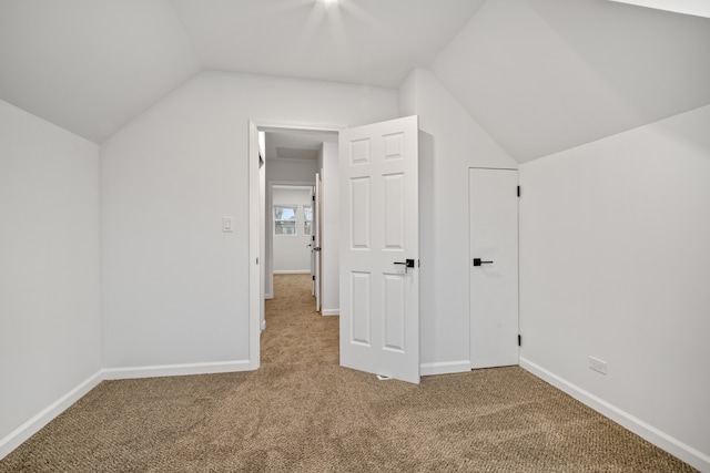 bonus room with carpet floors and vaulted ceiling