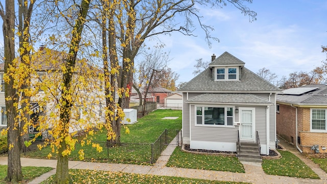 bungalow-style home with a front yard