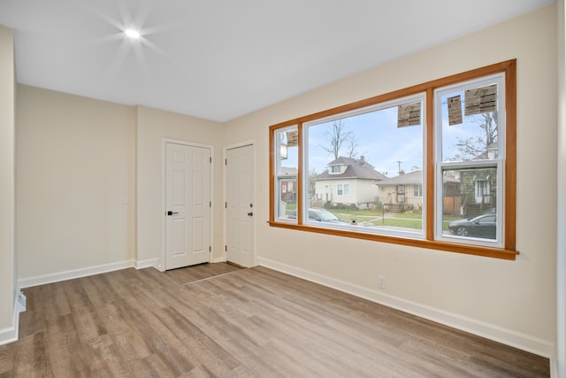 unfurnished room with light hardwood / wood-style floors