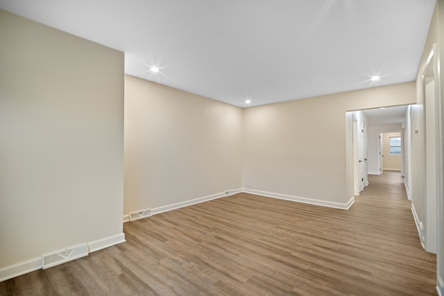 empty room with hardwood / wood-style floors