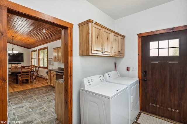 washroom with cabinets, dark hardwood / wood-style flooring, wood ceiling, an inviting chandelier, and washing machine and dryer