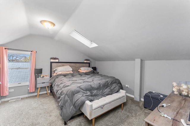 carpeted bedroom featuring vaulted ceiling with skylight