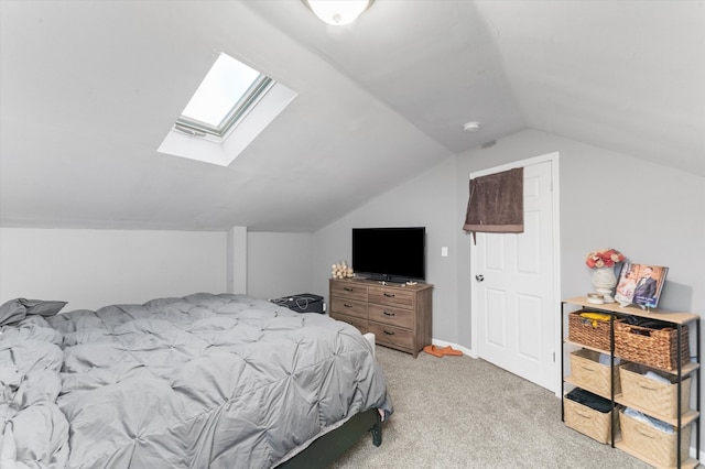 bedroom featuring light carpet and lofted ceiling with skylight