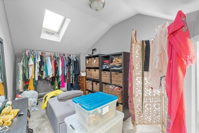 spacious closet with lofted ceiling with skylight and light carpet