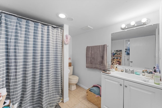 bathroom with tile patterned floors, walk in shower, vanity, and toilet