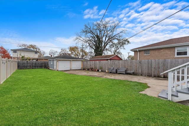 view of yard featuring a garage and an outbuilding