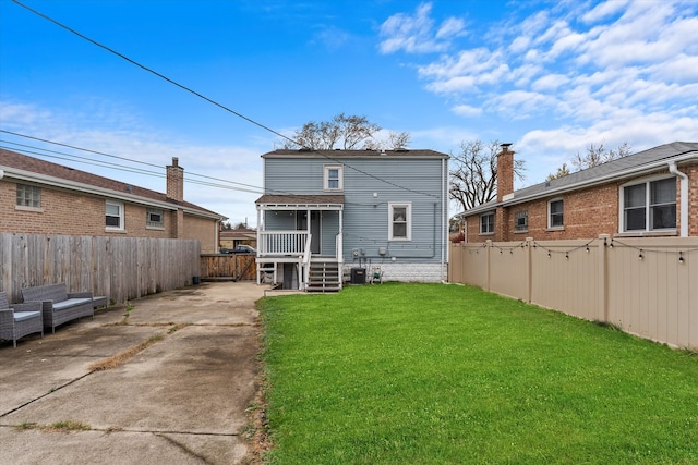 back of property with a yard and a deck