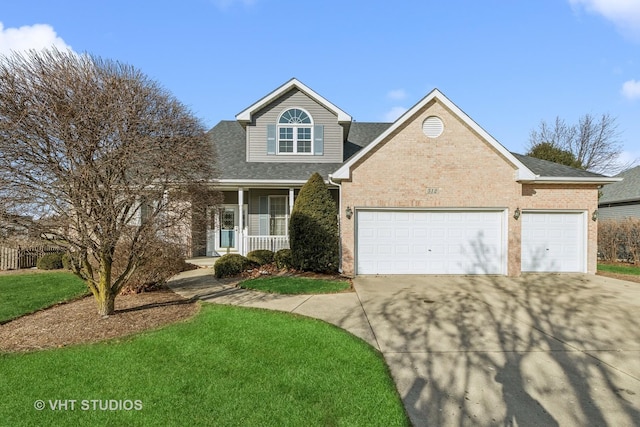 view of front of home featuring a garage, covered porch, and a front yard