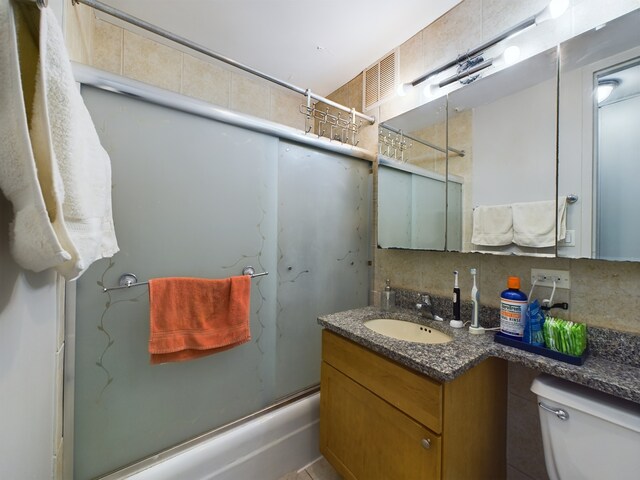 655 W Irving Park Rd Unit 1710, Chicago, IL 60613 - bathroom with shower / washtub combination, vanity, toilet, and decorative backsplash