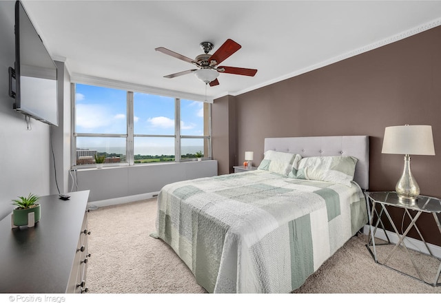 bedroom with ceiling fan, light colored carpet, and ornamental molding