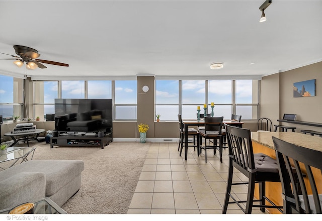 living room featuring ceiling fan, a healthy amount of sunlight, and light tile patterned floors