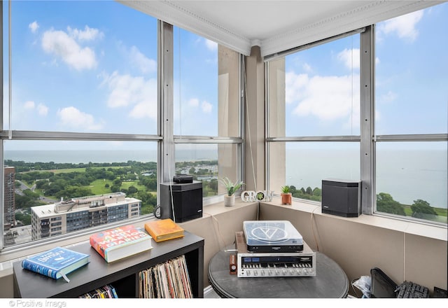 sunroom / solarium featuring a healthy amount of sunlight and a water view