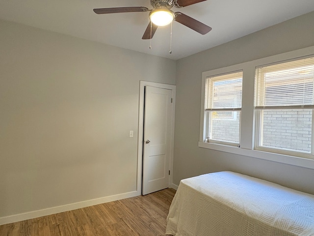 bedroom with ceiling fan and light wood-type flooring