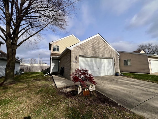 view of side of property with a lawn and a garage