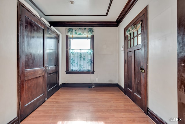 entrance foyer with light wood-type flooring and ornamental molding