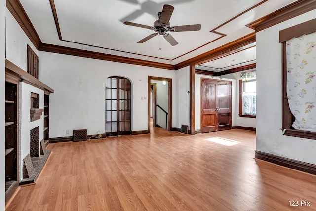 unfurnished living room with ceiling fan, light hardwood / wood-style floors, and ornamental molding