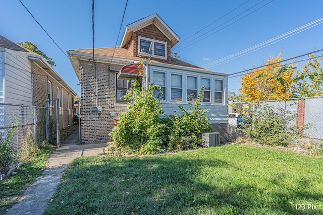 view of front facade with a front lawn and central AC unit