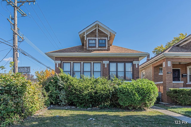 bungalow with a front yard