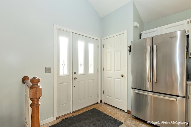 foyer entrance featuring lofted ceiling