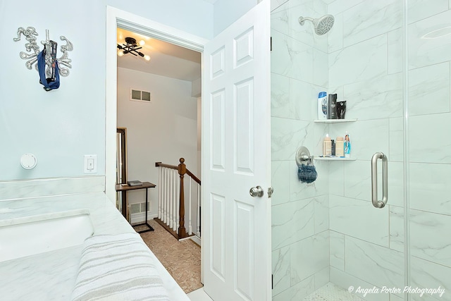 bathroom featuring vanity and a shower with shower door