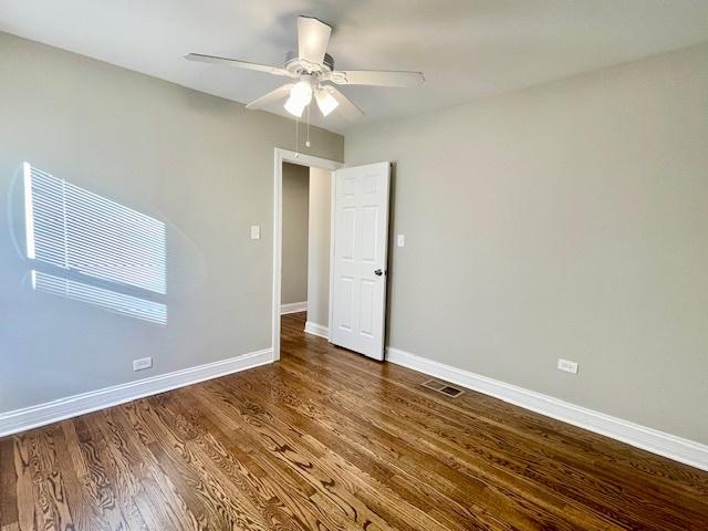 spare room featuring wood-type flooring and ceiling fan