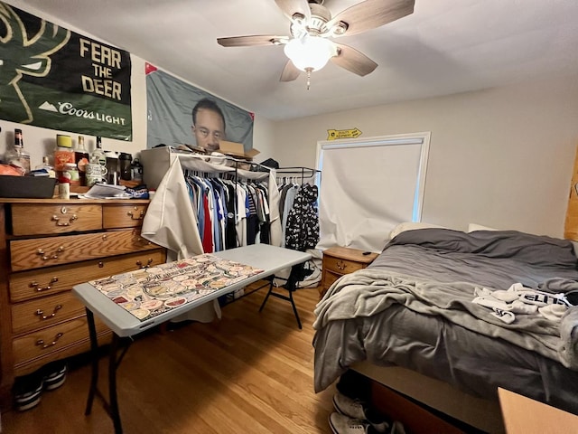 bedroom with light hardwood / wood-style flooring and ceiling fan